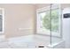 Bathroom with soaking tub and walk-in shower with glass door at 2995 Belshire Trl, Dacula, GA 30019