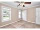 Cozy bedroom featuring neutral carpet, crown molding, ceiling fan, and bright windows at 2995 Belshire Trl, Dacula, GA 30019