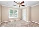 Neutral bedroom featuring plush carpet, ceiling fan, crown molding, and a bright window at 2995 Belshire Trl, Dacula, GA 30019