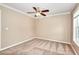 Neutral bedroom with a ceiling fan and a large window offering ample natural light at 2995 Belshire Trl, Dacula, GA 30019