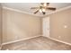 Tan carpeted bedroom with ceiling fan, crown molding, and neutral walls at 2995 Belshire Trl, Dacula, GA 30019
