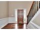 Welcoming entryway with a stained wood door, sidelights, and hardwood floors, next to a staircase at 2995 Belshire Trl, Dacula, GA 30019