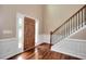 Inviting entryway features hardwood floors and a staircase with white trim and a black iron railing at 2995 Belshire Trl, Dacula, GA 30019