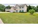 Attractive two-story home with lush lawn, cheerful turquoise shutters and door at 2995 Belshire Trl, Dacula, GA 30019
