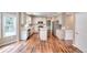 Bright kitchen boasts stainless appliances, granite counters, white cabinets, and hardwood flooring at 2995 Belshire Trl, Dacula, GA 30019
