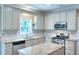 Bright kitchen with stainless steel appliances, granite countertops, and a view from the window at 2995 Belshire Trl, Dacula, GA 30019