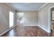 Spacious living room with hardwood floors, neutral paint, and an open doorway to staircase at 2995 Belshire Trl, Dacula, GA 30019