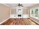 Spacious living room features a fireplace with built-in shelving and large windows at 2995 Belshire Trl, Dacula, GA 30019