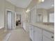 Bright bathroom featuring double vanity, tile floor, and access to the bedroom at 415 Winn Park Ct, Roswell, GA 30075