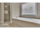 Serene primary bathroom with a soaking tub and separate glass-enclosed shower at 415 Winn Park Ct, Roswell, GA 30075