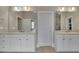 Elegant bathroom showcasing double sinks, large mirrors and neutral tile flooring at 415 Winn Park Ct, Roswell, GA 30075