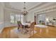 Elegant dining room with decorative trim, chandelier, and access to another room at 415 Winn Park Ct, Roswell, GA 30075