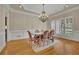 Elegant dining room with detailed trim, a stylish chandelier, and ample natural light at 415 Winn Park Ct, Roswell, GA 30075