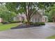 Beautiful brick home with a circular driveway, mature trees, and manicured landscaping at 415 Winn Park Ct, Roswell, GA 30075