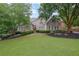 Charming brick home featuring a lush lawn and manicured landscaping, offering classic curb appeal at 415 Winn Park Ct, Roswell, GA 30075