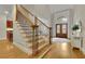 Grand foyer with wood staircase, hardwood floors, and decorative double front doors at 415 Winn Park Ct, Roswell, GA 30075
