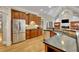 Spacious kitchen featuring stainless steel appliances, dark countertops, and ample cabinet space at 415 Winn Park Ct, Roswell, GA 30075