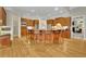Beautiful kitchen island with custom wood cabinets, hardwood flooring, and barstool seating at 415 Winn Park Ct, Roswell, GA 30075