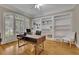 Bright office space with built-in shelving, hardwood floors, and a large window at 415 Winn Park Ct, Roswell, GA 30075
