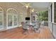 A covered brick patio features a dining table, chairs, and a ceiling fan at 415 Winn Park Ct, Roswell, GA 30075