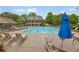 Community swimming pool with lounge chairs, tables, and a nearby building at 415 Winn Park Ct, Roswell, GA 30075