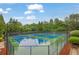 A tennis complex featuring multiple blue courts and lush greenery at 415 Winn Park Ct, Roswell, GA 30075