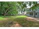 Lush green backyard with mature trees surrounds the home, offering a peaceful outdoor space at 4975 Rockstone Way, Acworth, GA 30101
