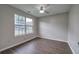 This bedroom has dark wood flooring and a ceiling fan at 4975 Rockstone Way, Acworth, GA 30101
