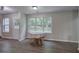 Bright dining area features wood-look flooring and a large window for natural light at 4975 Rockstone Way, Acworth, GA 30101
