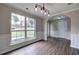 Light-filled dining area featuring an elegant archway, large window, modern lighting, and wood-look floors at 4975 Rockstone Way, Acworth, GA 30101