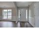 Bright foyer with a white front door, sidelights, wood-look floors, and a view to the living area with wainscotting at 4975 Rockstone Way, Acworth, GA 30101