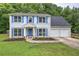 Charming two-story home featuring light blue siding, blue shutters, and a well-manicured lawn at 4975 Rockstone Way, Acworth, GA 30101