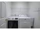 Convenient laundry room is equipped with modern washer, dryer, and shelving at 4975 Rockstone Way, Acworth, GA 30101