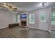 Cozy living room features a brick fireplace, mounted TV, and a ceiling fan at 4975 Rockstone Way, Acworth, GA 30101
