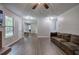 Open living area boasts hardwood floors, a comfortable sofa, and seamless transitions at 4975 Rockstone Way, Acworth, GA 30101