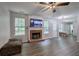 Open concept living area with fireplace, mounted TV, and access to the dining room at 4975 Rockstone Way, Acworth, GA 30101