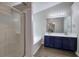 Bathroom featuring a glass enclosed shower, soaking tub, double sink vanity, and updated lighting at 4975 Rockstone Way, Acworth, GA 30101