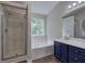 Bathroom featuring a glass enclosed shower, soaking tub, double sink vanity, and updated lighting at 4975 Rockstone Way, Acworth, GA 30101