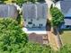 Aerial shot of the backyard with patio, garden beds, and privacy fence at 1186 Hawthorn Ln, Grayson, GA 30017