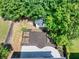 Aerial backyard showcases a shed, garden beds, patio, and fenced yard at 1186 Hawthorn Ln, Grayson, GA 30017