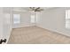 A well-lit bedroom featuring carpet, white walls, and two windows at 1186 Hawthorn Ln, Grayson, GA 30017