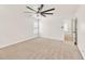 A spacious bedroom with neutral carpet, white walls, and ceiling fan at 1186 Hawthorn Ln, Grayson, GA 30017
