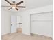 A well lit bedroom featuring an ceiling fan and a closet with metal racks at 1186 Hawthorn Ln, Grayson, GA 30017