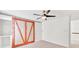 Bedroom with closet, white walls and trim, and a barn door with wooden trim at 1186 Hawthorn Ln, Grayson, GA 30017