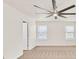 A well-lit bedroom featuring carpet, white walls, and windows at 1186 Hawthorn Ln, Grayson, GA 30017