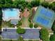 An aerial view showing a community pool, tennis courts, and lush landscaping at 1186 Hawthorn Ln, Grayson, GA 30017