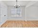 Well-lit dining area boasts a window, chandelier, and hardwood floors, perfect for Gathering meals at 1186 Hawthorn Ln, Grayson, GA 30017