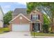 Charming brick two-story home with well-manicured lawn, attached garage and inviting entryway at 1186 Hawthorn Ln, Grayson, GA 30017
