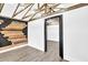 Unique interior with wood-look floors, black door frame, and wood accent wall at 1186 Hawthorn Ln, Grayson, GA 30017