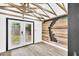 Unique interior with wood-look floors, beams on the ceiling, and wood accent wall at 1186 Hawthorn Ln, Grayson, GA 30017